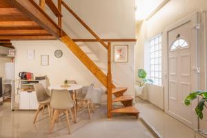 a kitchen and dining room with a table and chairs at Urban Nest in Sevran
