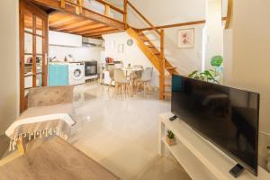 a living room with a large flat screen tv at Urban Nest in Sevran