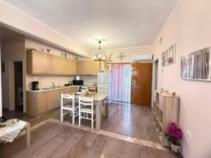 a kitchen with a table and a dining room at Mythos House in Palekastron +2 photos