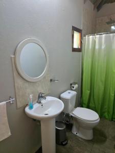 a bathroom with a sink and a toilet and a mirror at Lagoon Bay Chidenguele in Chidenguele +56 photos