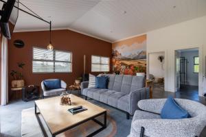 a living room with a couch and a table at Cape Dutch Stay, Suite A in Sedgefield