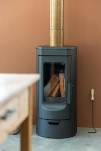 a small wood stove sitting in a room at Cape Dutch Stay, Suite A in Sedgefield +51 photos