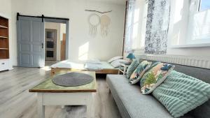 a living room with a couch and a table at Apartmány LENKA in Mikulášovice +27 photos