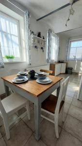 a wooden table and chairs in a kitchen at Apartmány LENKA in Mikulášovice
