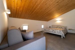 a bedroom with a bed and a wooden ceiling at GuestHost - Borgo 84 Marzamemi - Terrazza Mare in Marzamemi +22 photos