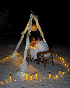 a couple sitting at a table in a tent on the beach at VR CLUB Tulum Riviera in Tulum +148 photos