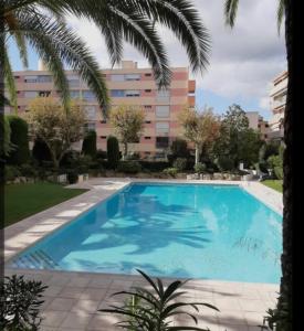 a large blue swimming pool in front of a building at L'échappée Méditerrannée in Vallauris +3 photos