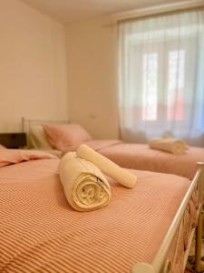 a room with two beds with a towel on them at Pink House - InBorgo in Acquasparta