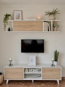 a flat screen tv sitting on top of a entertainment center at Casa Ona in Pontevedra
