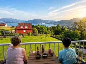 a man and woman sitting at a table on a balcony at Casa Ona in Pontevedra