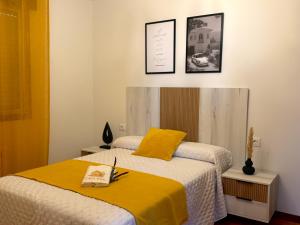 a bedroom with a bed with a yellow blanket at Casa Ona in Pontevedra +28 photos
