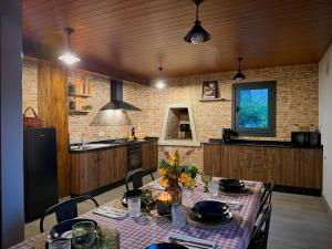 a kitchen with a table with chairs and a table cloth at Casa Ona in Pontevedra
