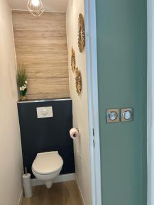 a bathroom with a toilet and a blue wall at L'échappée Méditerrannée in Vallauris