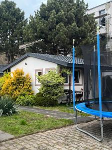 a blue chair in front of a house at Domki 13-nastka in Międzyzdroje