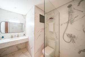 a bathroom with a shower and a sink and a toilet at Ocean Breeze 2BR Ocean View Rabat Corniche in Rabat +19 photos