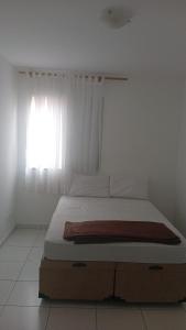 a bed in a white room with a window at SP , Interlagos,Expo Transamérica, 3 Hosp in São Paulo
