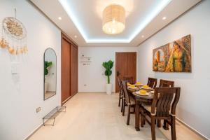 a dining room with a table and chairs at Ocean Breeze 2BR Ocean View Rabat Corniche in Rabat