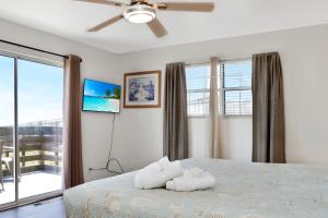 a bedroom with a bed and a large window at Amethyst Dunes by Pristine Properties Vacation Rentals in Indian Pass