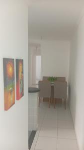 a hallway with a table and paintings on the wall at SP , Interlagos,Expo Transamérica, 3 Hosp in São Paulo