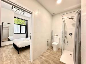 a bathroom with a bed and a shower and a toilet at Ciudades de España in Valencia +45 photos