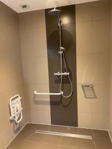 a shower stall in a bathroom with a shower head at Logis Hôtel Restaurant LE MONARQUE 30 Parking Vélos Sécurisé in Blois +43 photos