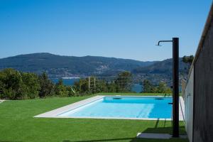 a swimming pool in the middle of a grassy yard at Casa Ona in Pontevedra