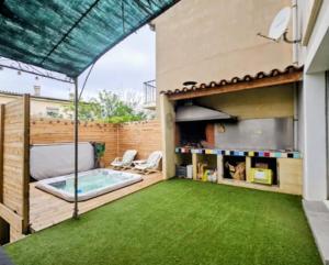 a backyard with a swimming pool and green grass at Villa Mars YourHostHelper in Narbonne