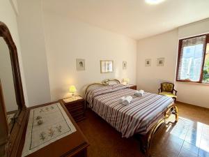 a bedroom with a bed with a striped bedspread at Francesca Appartamento con giardino in Levanto