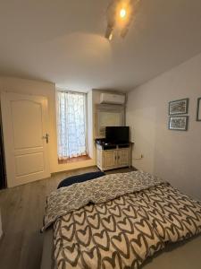 a bedroom with a bed and a window and a door at Apartments Rome in Baška +22 photos