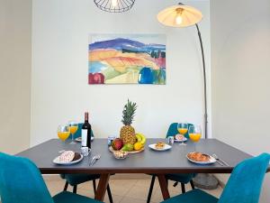 a table with a bowl of fruit and a bottle of wine at Tavira Escape with Pool by BeCherish in Tavira