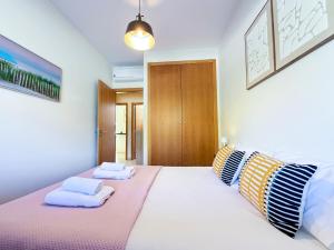 a bedroom with a large bed with two pillows at Tavira Escape with Pool by BeCherish in Tavira +38 photos