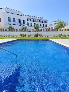 a large swimming pool in front of a building at Tavira Escape with Pool by BeCherish in Tavira