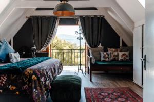 a bedroom with a bed and a large window at The Red Door in Clarens