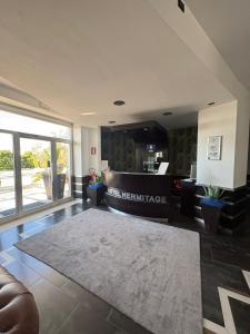 an office lobby with a reception desk and a living room at Hotel Hermitage in Qualiano