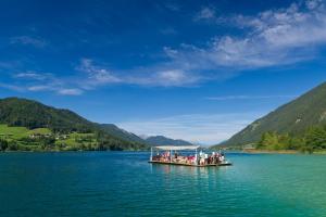 a group of people on a dock on a lake at Haus Stampfer in Weissensee