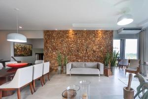 a dining room and living room with a stone wall at Haras Ammi Shaddai in Cuitegi