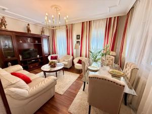 a living room with a couch and a table at Casa La Tabierna Suances - Monabri in Suances