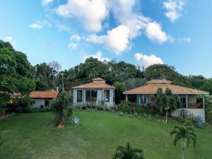 a house with a large yard in front of it at Haras Ammi Shaddai in Cuitegi