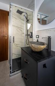 a bathroom with a sink and a glass shower at Villa Buby in Pettenasco +34 photos