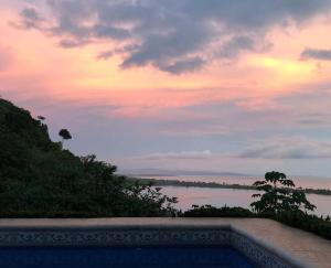 a view of the ocean from a pool at sunset at Club Fred in Punta Mala