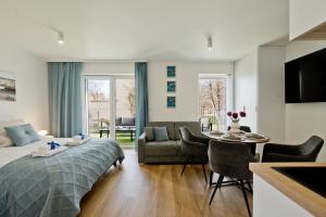 a bedroom with a bed and a living room at Casa Baia BlueApart Hel in Hel