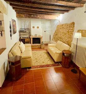 a living room with two couches and a fireplace at San Gemini Astolfi - InBorgo in San Gemini