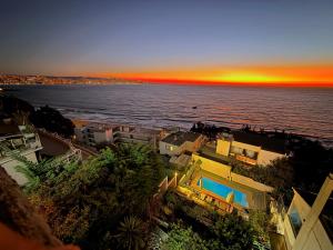 an aerial view of the ocean with a sunset at Dei Templi Hotel in Viña del Mar