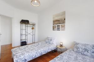 a living room with a bed and a table at Azuaga House Sunny Charming Apt in Vila Nova de Gaia