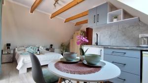 a kitchen with a table with two bowls on it at Willa Jarmar - sala kominkowa z bilardem, wewnętrzny oraz zewnętrzny plac zabaw in Brenna