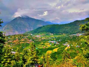 a town in a valley with mountains in the background at Sukun Hostel in Sainj