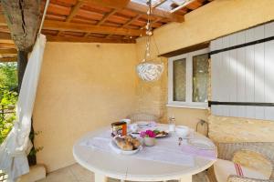 a white table with food on it on a patio at Les Orchidées - Chambre in Savignac-de-Miremont