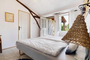 a bedroom with a white bed with a window at Les Orchidées - Chambre in Savignac-de-Miremont