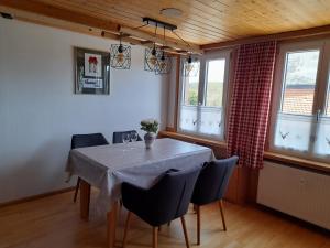 a dining room with a table and chairs and windows at Kopf Frei auf 1000 Meter Wohnung 1 in Feldberg +37 photos