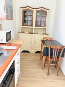 a kitchen with a desk and a table with a chair at La Tana de Il Lupo e La Volpe in Centobuchi +3 photos